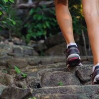 legs walking up outdoor concrete stairs
