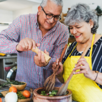 Senior couple cooking dinner together